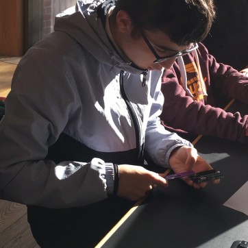 Boy measuring arduino